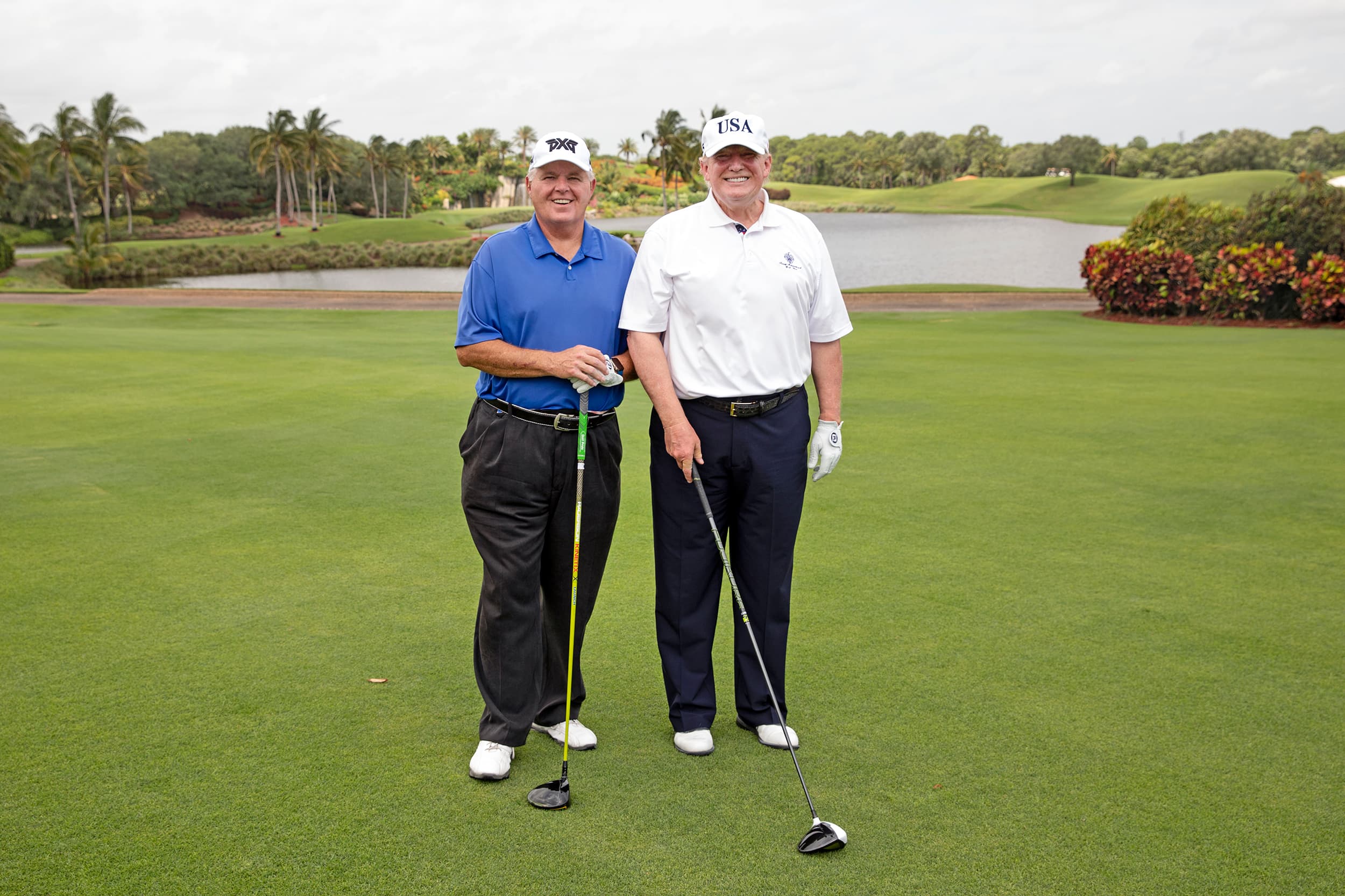 Donald Trump standing on a golf course at Trump International Golf Club in West Palm Beach.